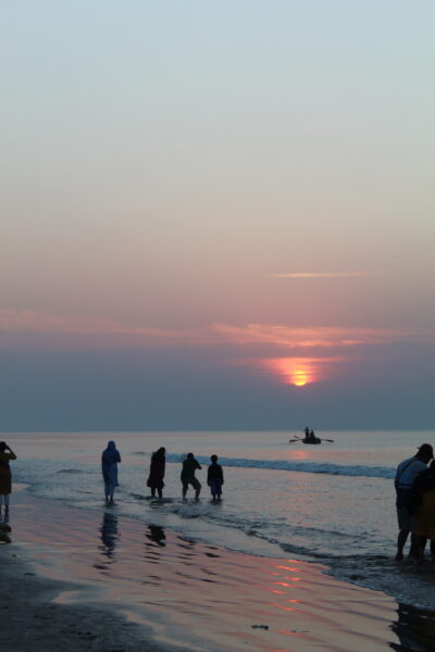 Beachside Delight as People Bask in the Sunset’s Glow